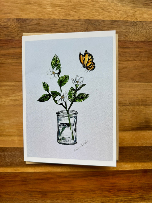 Watercolor of Na'u gardenia flowers in a glass furikake jar as a vase with water as a monarch butterfly flying nearby on a greeting card that is blank inside